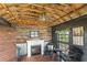 Cozy interior with wood paneling, fireplace, unique chandelier, and rustic accents at 7823 Baron Ave, Howey In The Hills, FL 34737