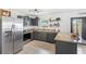 Modern kitchen featuring stainless steel appliances, granite countertops, and ample cabinet space at 7823 Baron Ave, Howey In The Hills, FL 34737