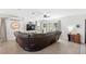 Bright and airy living room with tile floors and a comfortable wrap around leather sofa at 7823 Baron Ave, Howey In The Hills, FL 34737