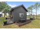Gray shed with planter boxes, garden beds, and string lights on a spacious lot at 7823 Baron Ave, Howey In The Hills, FL 34737