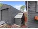 Exterior view of gray shed and small chicken coop with metal roof at 7823 Baron Ave, Howey In The Hills, FL 34737