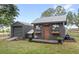 Charming shed and storage building, painted gray with a metal roof and cute 'Feed & Seed Co.' sign at 7823 Baron Ave, Howey In The Hills, FL 34737