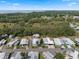 An aerial view of a cozy mobile home community surrounded by lush greenery and a glimpse of the nearby lake at 8 Cocos Plumosa Dr # A, Eustis, FL 32726