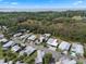 An aerial view of a charming mobile home community surrounded by lush trees and a glimpse of the nearby lake at 8 Cocos Plumosa Dr # A, Eustis, FL 32726