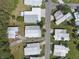 Aerial view of the neighborhood displaying street access and rooftops of the adjacent homes at 8 Cocos Plumosa Dr # A, Eustis, FL 32726