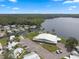 Aerial view of community featuring lake access, clubhouse, and well-maintained landscaping on a sunny day at 8 Cocos Plumosa Dr # A, Eustis, FL 32726