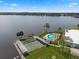 Aerial view showcases the community pool, shuffleboard, and boat docks on the tranquil lake at 8 Cocos Plumosa Dr # A, Eustis, FL 32726
