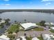 Aerial view showcasing the clubhouse with parking, pool, shuffleboard, and boat docks by the lake at 8 Cocos Plumosa Dr # A, Eustis, FL 32726
