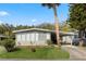 Charming single-story home with well-maintained landscaping, covered parking, and a welcoming facade at 8 Cocos Plumosa Dr # A, Eustis, FL 32726
