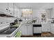 Cozy kitchen features bright white cabinets and appliances, plus a window over the sink at 8 Cocos Plumosa Dr # A, Eustis, FL 32726