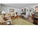 Cozy living room featuring a comfortable sofa, decorative rug, and a TV on a console table at 8 Cocos Plumosa Dr # A, Eustis, FL 32726