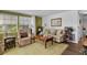 Relaxing living room with a comfortable sofa, recliner, and soft natural light at 8 Cocos Plumosa Dr # A, Eustis, FL 32726