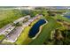 Aerial view of condo community with manicured lawns, pond, and golf course at 9423 Myrtle Creek Ln # 510, Orlando, FL 32832