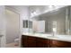 Bathroom featuring double sinks, dark wood cabinets, and a large mirror at 9423 Myrtle Creek Ln # 510, Orlando, FL 32832