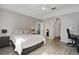 Bedroom featuring a queen-sized bed, neutral walls, and light wood laminate flooring at 9423 Myrtle Creek Ln # 510, Orlando, FL 32832
