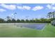 Community tennis courts surrounded by lush landscaping and tall trees at 9423 Myrtle Creek Ln # 510, Orlando, FL 32832