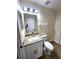 Well-lit bathroom featuring modern fixtures, granite countertops, and a framed mirror at 101 Dovetail Ct, Apopka, FL 32703
