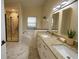 Spacious bathroom featuring double sinks, a tub, and a glass-enclosed shower with stylish marble tiling at 101 Dovetail Ct, Apopka, FL 32703