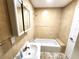 Clean bathroom featuring a tub, sink, and a mirrored medicine cabinet at 101 Dovetail Ct, Apopka, FL 32703
