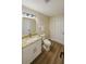 Bright bathroom featuring a vanity with granite countertop, gold hardware and light wood-look floors at 101 Dovetail Ct, Apopka, FL 32703