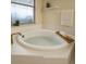 Close up shot of a well-lit bathtub with tile surround and brass fixtures at 101 Dovetail Ct, Apopka, FL 32703