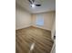Clean, empty bedroom with wood-look flooring, ceiling fan, and ample natural light at 101 Dovetail Ct, Apopka, FL 32703