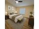Bright bedroom with a ceiling fan, a bed with end tables and lamps, and a dresser with decor at 101 Dovetail Ct, Apopka, FL 32703