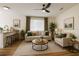 Cozy living room with modern ceiling fan, neutral decor, wood-look floors, and lots of natural light at 101 Dovetail Ct, Apopka, FL 32703