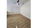 Open living room area with wood-style flooring, a ceiling fan, and natural light at 101 Dovetail Ct, Apopka, FL 32703