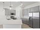 Bright kitchen features gray cabinets, stainless steel appliances, subway tile backsplash, and quartz countertops at 10353 Ebb Tide Ln, Orlando, FL 32821