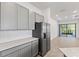 Bright eat-in kitchen features tile flooring and stainless steel appliances with an adjacent living area at 10353 Ebb Tide Ln, Orlando, FL 32821