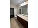 Bathroom with dark wood cabinets, tile floors, and separate shower at 11446 Jasper Kay Terrace # 202, Windermere, FL 34786