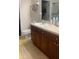 Bathroom featuring dark cabinets, a white sink, and tile flooring at 11446 Jasper Kay Terrace # 202, Windermere, FL 34786