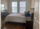Comfortable bedroom with two windows allowing natural light, dresser, nightstand and queen-sized bed at 11446 Jasper Kay Terrace # 202, Windermere, FL 34786