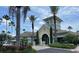 Community clubhouse with beautiful landscaping and golf cart parking at 11446 Jasper Kay Terrace # 202, Windermere, FL 34786