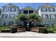 Well-maintained building featuring lush landscaping, benches, and a screened-in porch on the second level at 11446 Jasper Kay Terrace # 202, Windermere, FL 34786