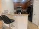 Modern kitchen with stainless steel microwave and appliances, dark wood cabinets and granite countertops at 11446 Jasper Kay Terrace # 202, Windermere, FL 34786