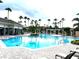 Bright, spacious community pool surrounded by lush landscaping and comfortable lounge seating at 11446 Jasper Kay Terrace # 202, Windermere, FL 34786