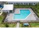 Aerial view of the community pool area, surrounded by lush landscaping and lounge chairs at 1533 Heritage Pl, Oviedo, FL 32765