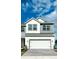 Charming two-story home with a white garage door and gray and white siding at 1533 Heritage Pl, Oviedo, FL 32765