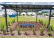 Community area featuring a shaded pergola with a blue bench and manicured landscaping at 1533 Heritage Pl, Oviedo, FL 32765