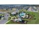 A vibrant community pool area with palm trees, a splash pad, a playground, and nearby parking offers many recreational opportunities at 1803 Perch Hammock Loop, Groveland, FL 34736