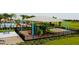 This playground is equipped with slides, a climbing structure, swings, and a shaded canopy for safe outdoor fun at 1803 Perch Hammock Loop, Groveland, FL 34736