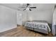 Bedroom with wood floors, ceiling fan, and connected bathroom entrance at 1831 W Clinton Dr, St Cloud, FL 34769