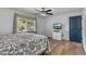 Cozy bedroom with natural light, wood floors, and a blue accent door at 1831 W Clinton Dr, St Cloud, FL 34769