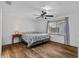 Bright bedroom with wood floors, a ceiling fan, and natural light from a large window at 1831 W Clinton Dr, St Cloud, FL 34769