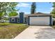 Charming exterior features a two-car garage, complemented by a well-manicured lawn and inviting curb appeal at 1831 W Clinton Dr, St Cloud, FL 34769