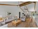 Cozy living room with wood look floors, neutral furnishings and vaulted ceilings at 1831 W Clinton Dr, St Cloud, FL 34769