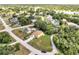 Aerial view showing the home in a neighborhood with nearby ponds and mature trees at 2004 Prescott Blvd, Deltona, FL 32738