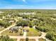 Aerial view of the home near a lake in a wooded area at 2004 Prescott Blvd, Deltona, FL 32738